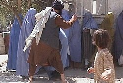 Taliban beating woman in publi